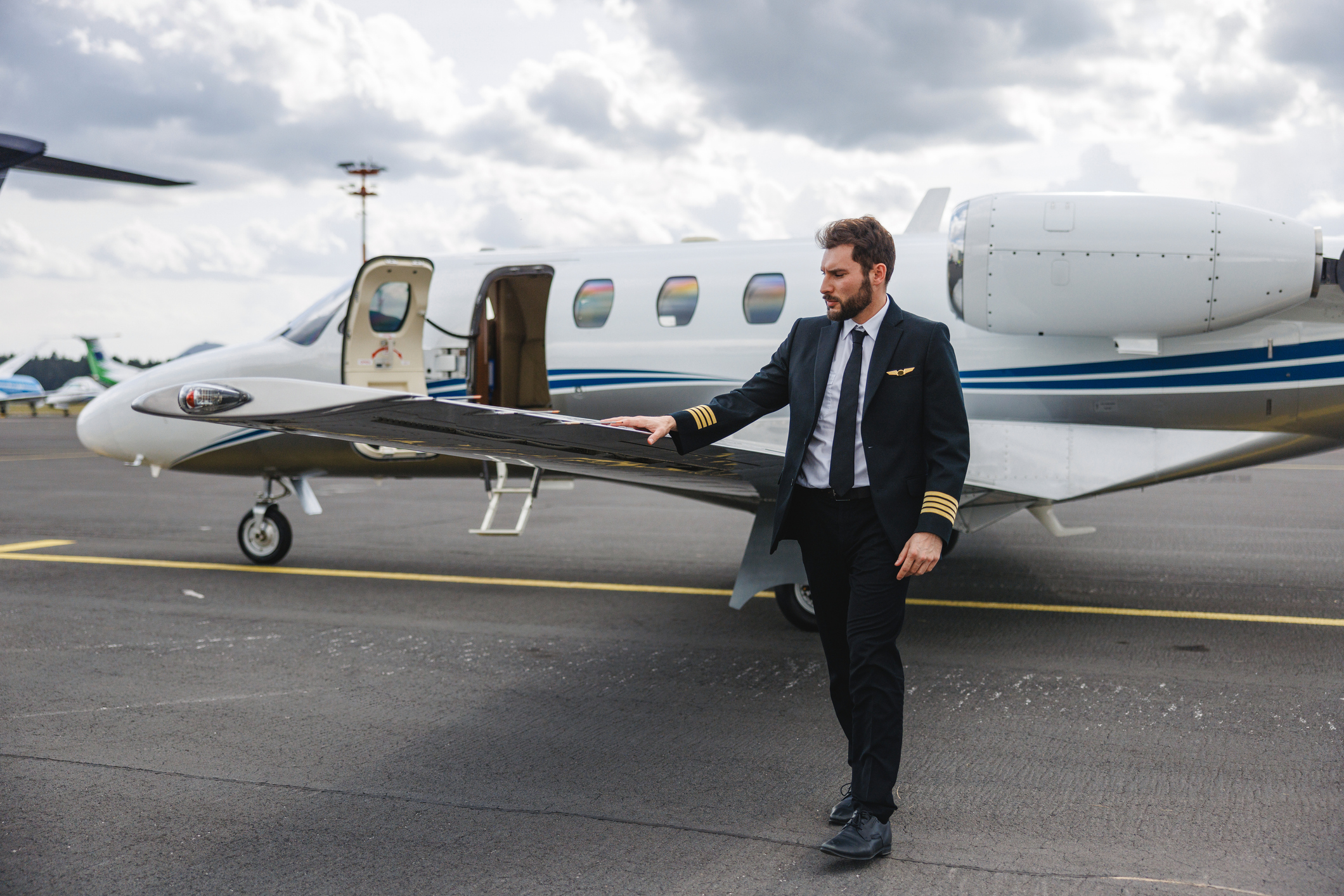 Confident Pilot Checking Private Jet Before Flight